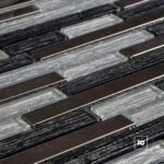 Close-up of parallel dark metal bars interleaved with silver textured strips in an industrial surface.