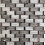 Malla30x30-nantes-cenezzia-ok | Plomería García Close-up of a decorative wall tiling pattern with light and dark rectangular bricks and small bronze metal accents.