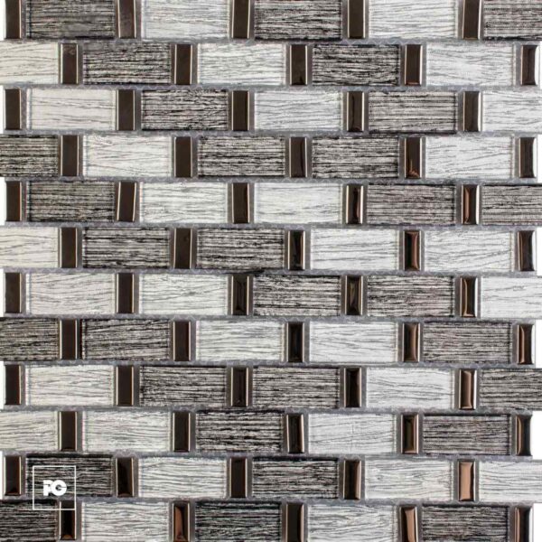 Close-up of a decorative wall tiling pattern with light and dark rectangular bricks and small bronze metal accents.