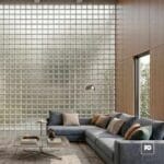 Vidrio block 19x19x8-transparente-cruzado-foncer-plomeria garcia-2-ok | Plomería García Modern living room with a blue-gray sectional, neutral pillows, glass coffee table, and a glass-block wall.