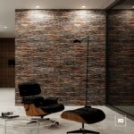 Fachaleta oxido-30x60-teide-cenezzia-2-ok | Plomería García Mid-century modern lounge: black leather eames chair and ottoman, glass coffee table, textured stone wall.