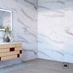 Piso porcelanico rectificado color gold-60x120-pulido-interior-pompeii-castel-2-ok | Plomería García Modern bathroom with white marble tile walls, a floating wooden vanity, and a backlit rectangular mirror reflecting plants on the counter.